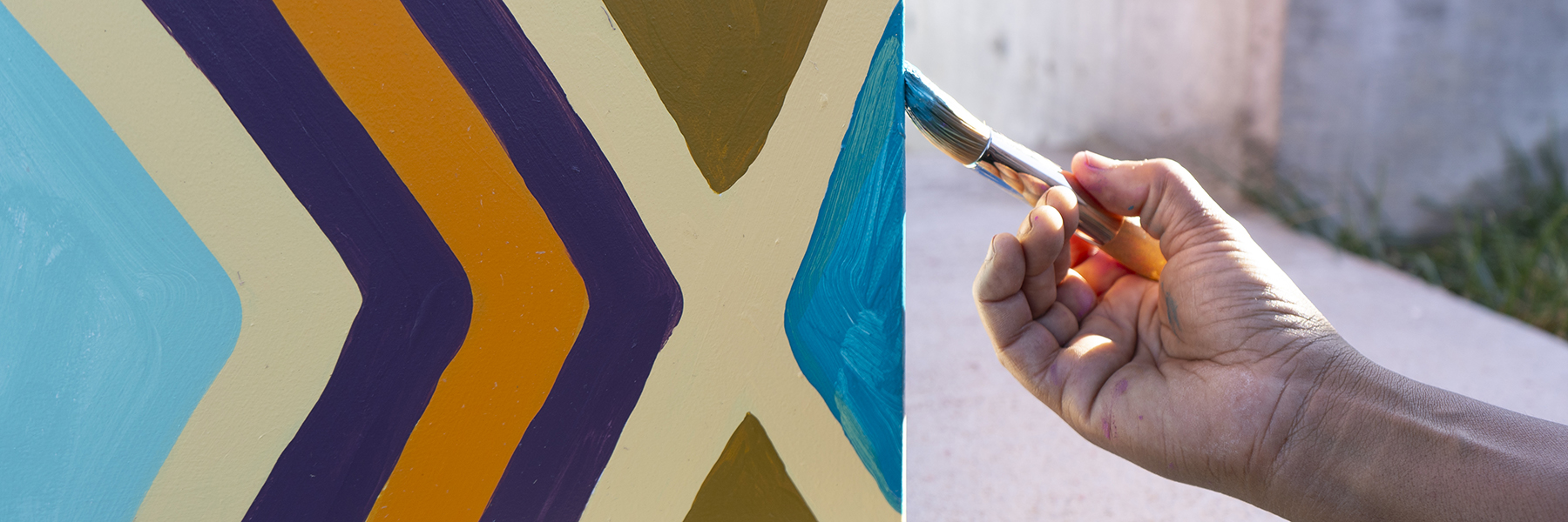 Hand painting a diamond on a mural
